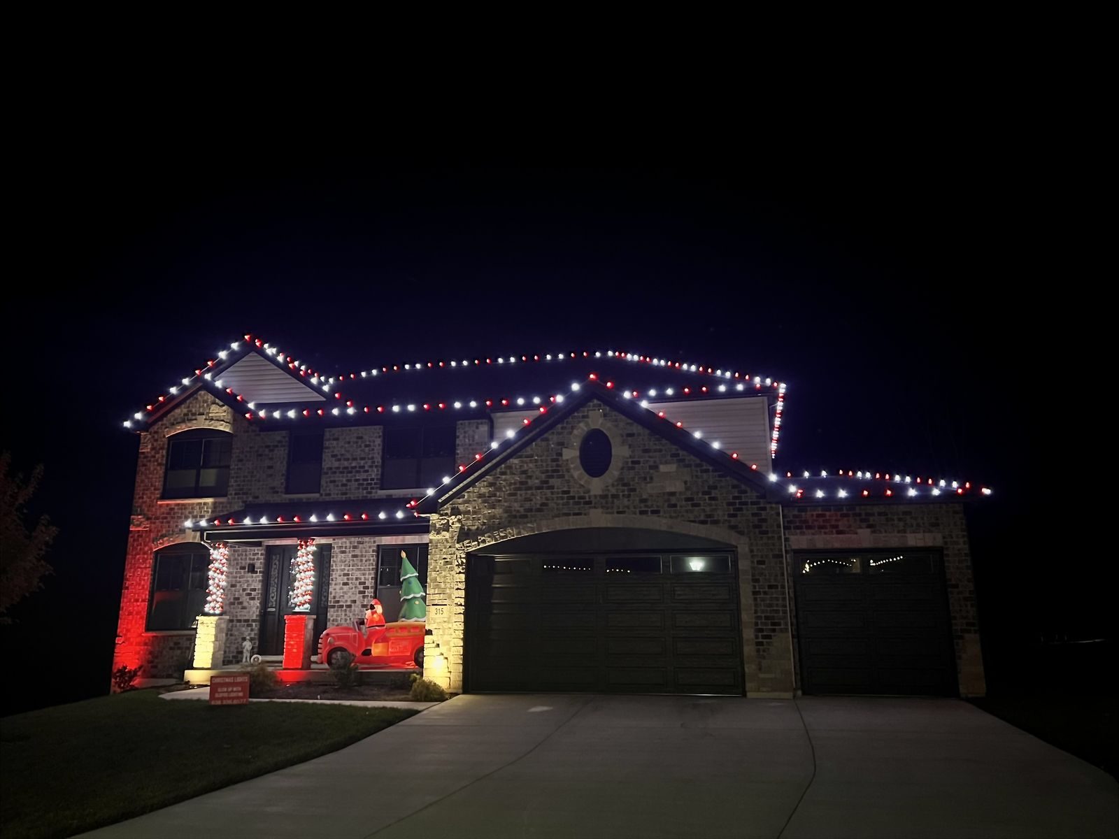 A Santa Squad Christmas light installation at night
